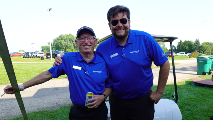 Two men standing next to each other. 
