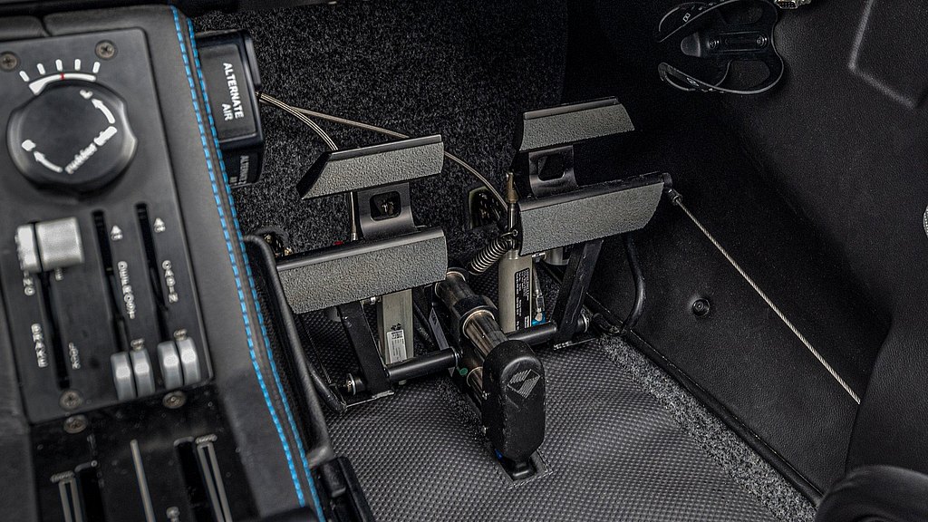 Close-up view of aircraft rudder pedals, showcasing their design and placement within the cockpit environment.