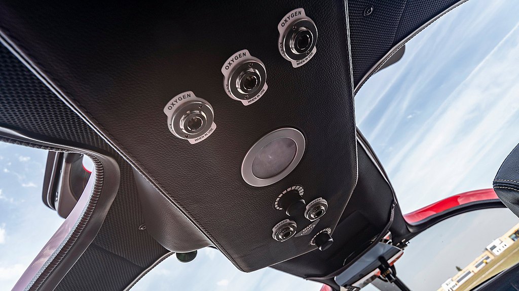 The interior view of a sleek aircraft cockpit, showcasing oxygen supply controls and a modern design aesthetic.