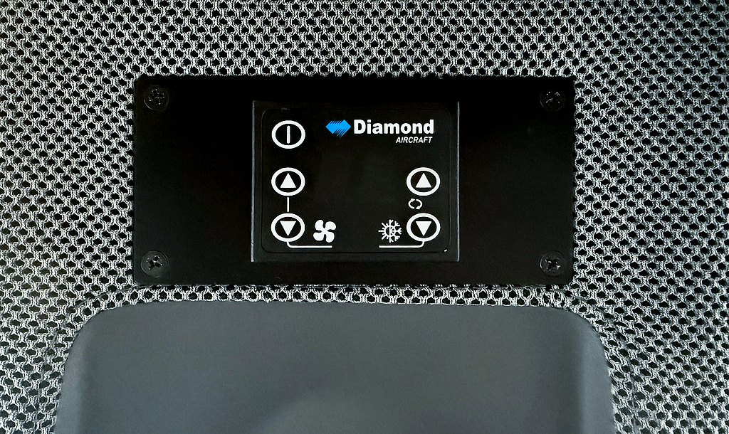 Control panel for air conditioning in a DA50 RG, featuring buttons for fan speed and temperature adjustments.
