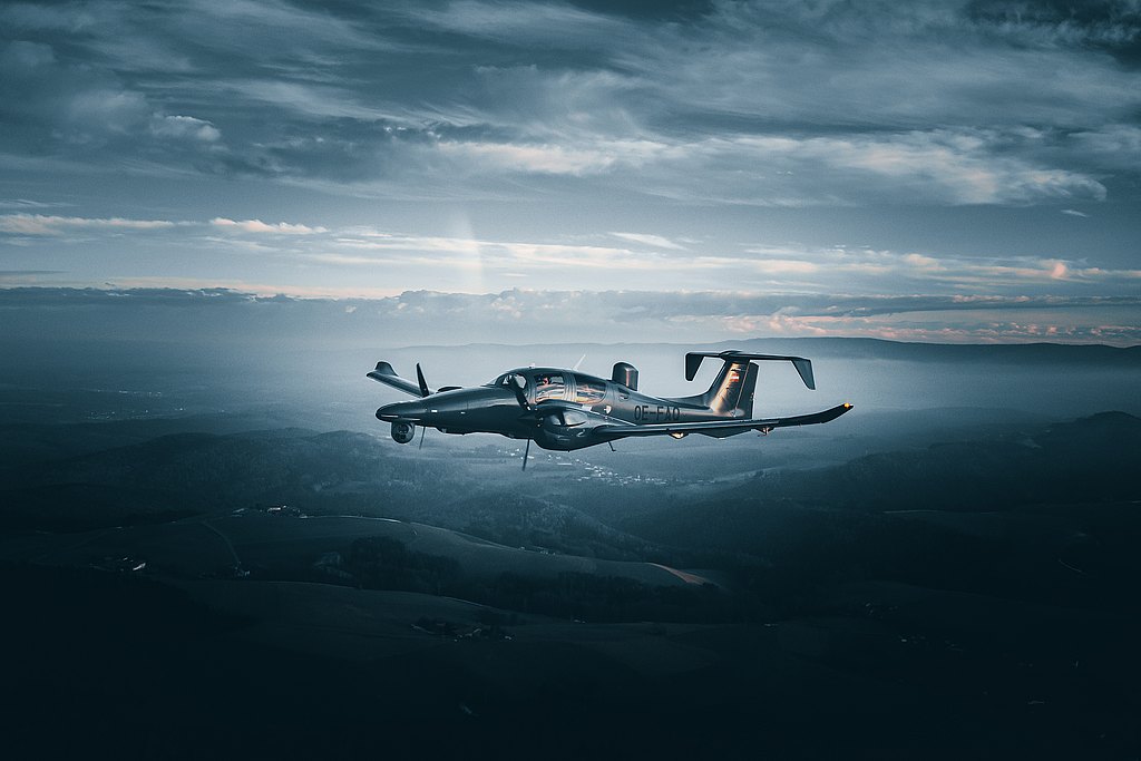 DA62 MPP flying over hills. 