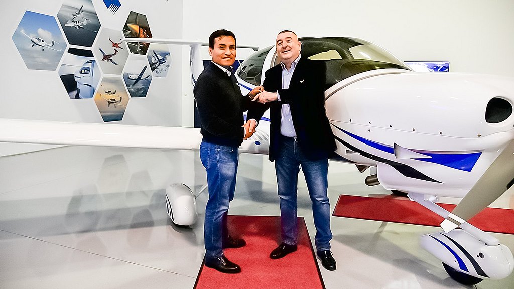 Sales Manager handing over the aircraft keys to the customer.