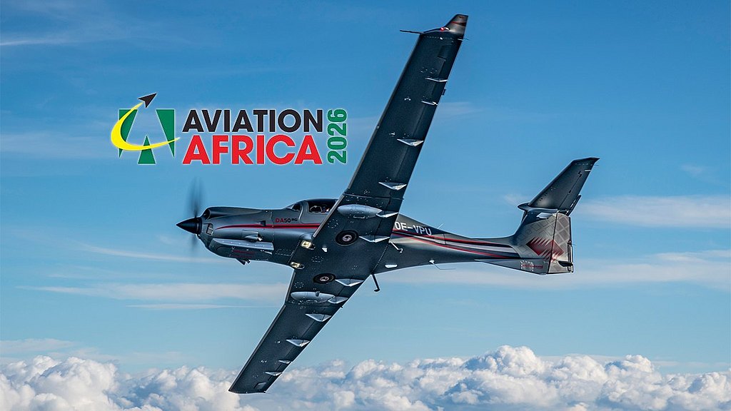 A DA50 RG aircraft soars through a bright blue sky, surrounded by fluffy white clouds, showcasing its impressive design.