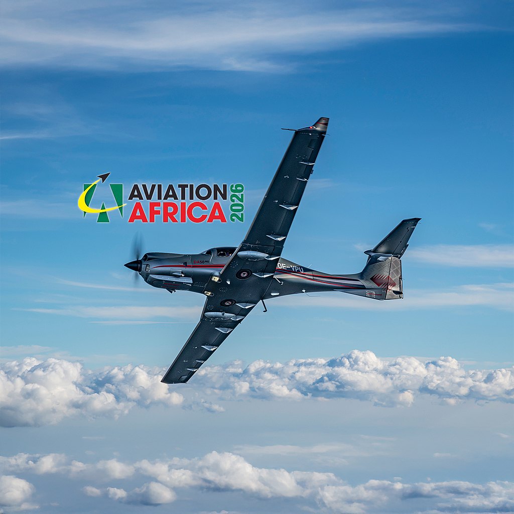 A DA50 RG aircraft soars through a bright blue sky, surrounded by fluffy white clouds, showcasing its impressive design.