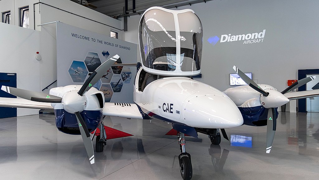 CAE DA42-VI with open canopy standing in a hangar.  
