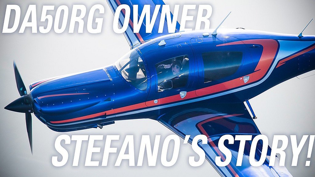 The pilot, wearing sunglasses, confidently salutes from the cockpit of a striking blue and orange DA50 RG airplane in flight.