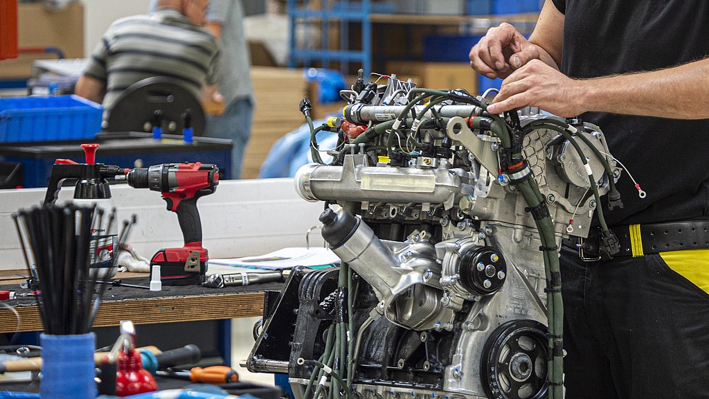 Production worker working on an engine.
