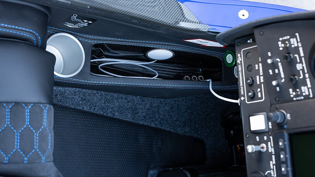 Detailed interior shot showcasing a cable holder with metallic fittings, surrounded by textured surfaces and control levers.