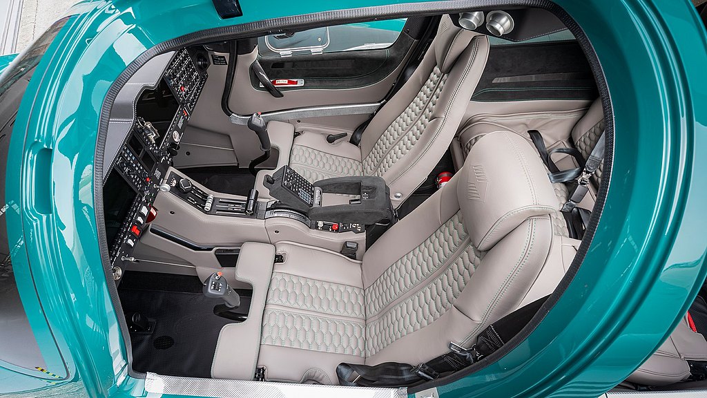 The luxurious cockpit features plush tan leather seats and a sleek control panel filled with advanced instruments.