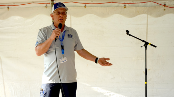 Man speaking with a microphone.