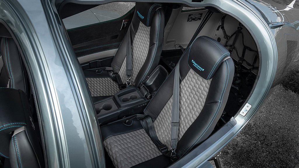 The interior features two high-end seats with a unique texture, emphasizing comfort and safety in a contemporary aircraft setting.