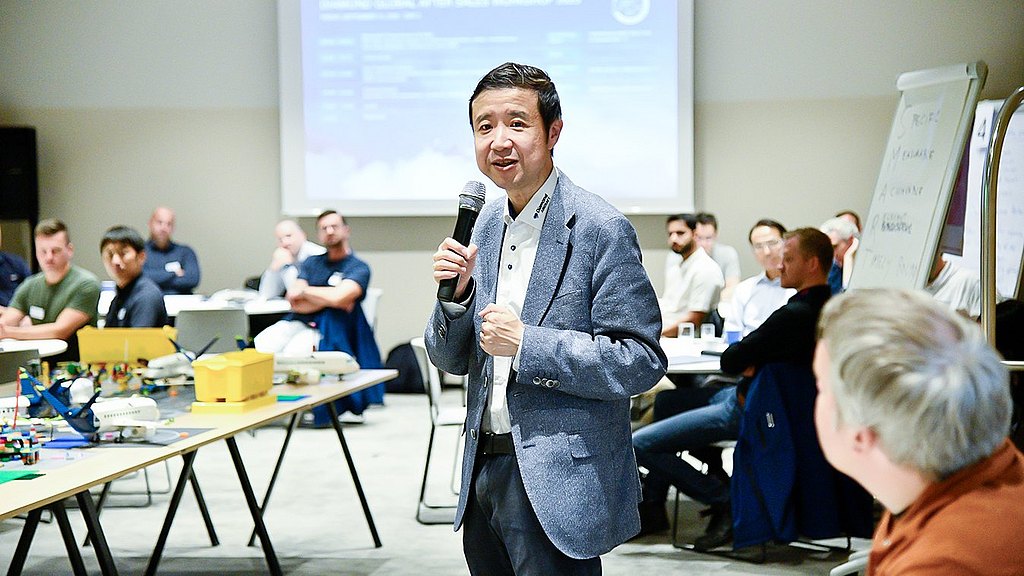 Man with a microphone giving a presentation during the workshop. 