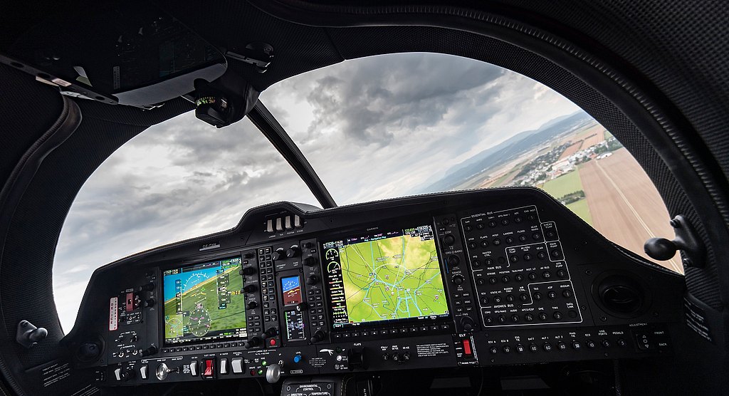 DA50 RG cockpit view during flight with pilot handling the center stick. 