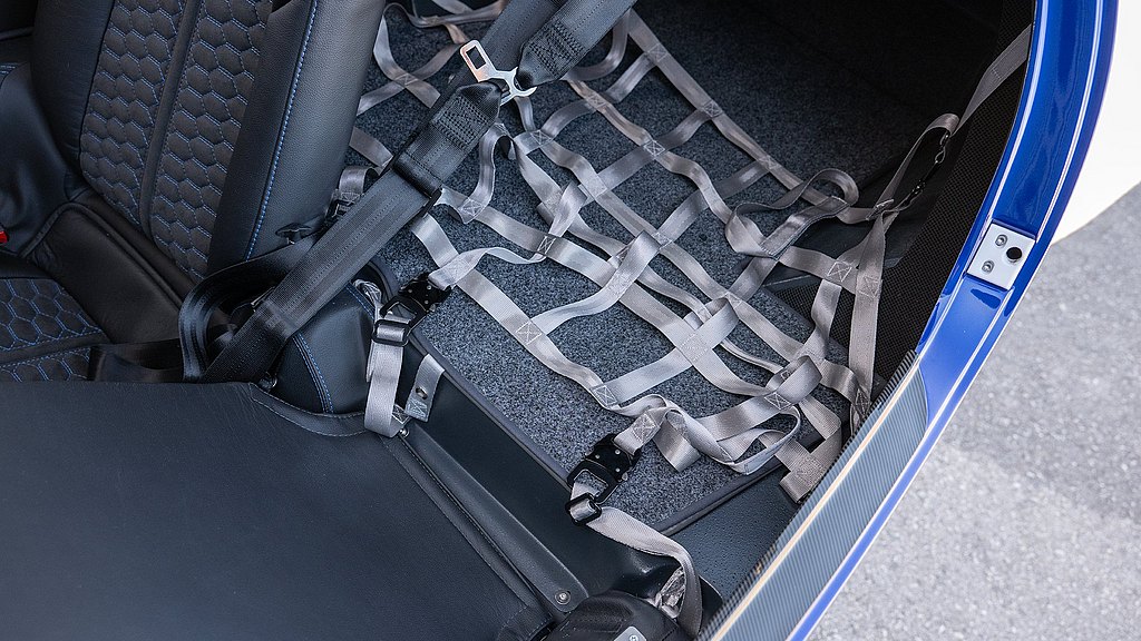 An interior view of a DA42's baggage compartment with a harness to secure luggage. 
