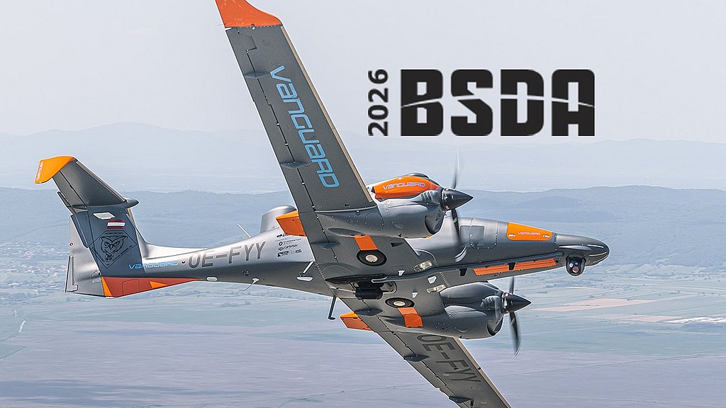 A DA62 MPP aircraft with orange accents soars through a clear sky, showcasing its impressive design and agility in flight.