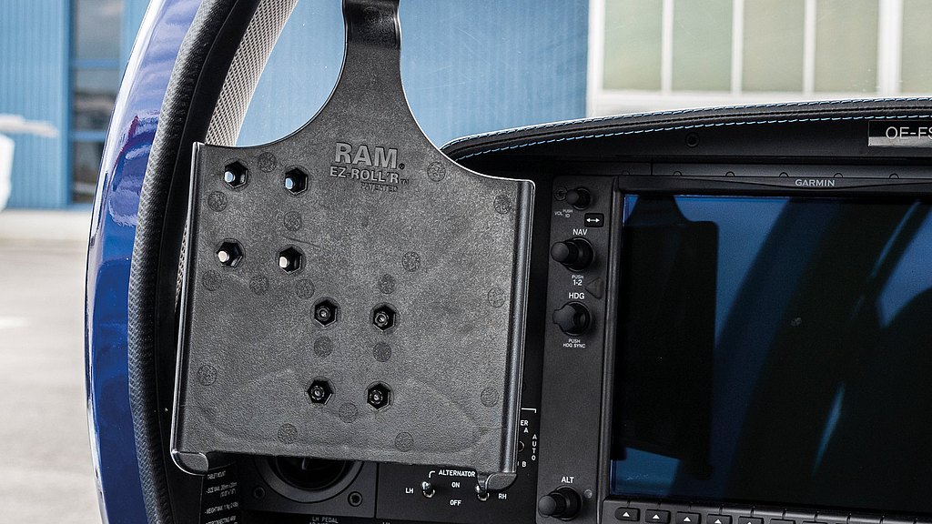 The cockpit features a RAM tablet mount, highlighting its integration with various flight controls and a sleek display screen.