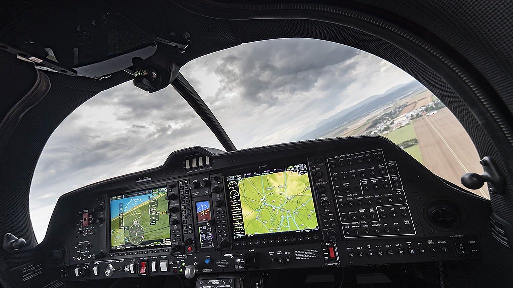 DA50 RG cockpit view during flight with pilot handling the center stick. 