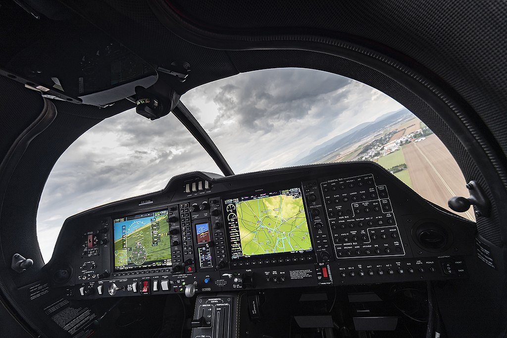 DA50 RG cockpit view during flight with pilot handling the center stick. 