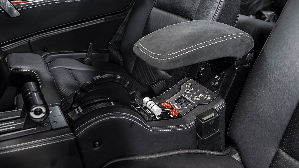 A sleek black DA62 aircraft interior featuring a central armrest with controls, emphasizing luxury and functionality.