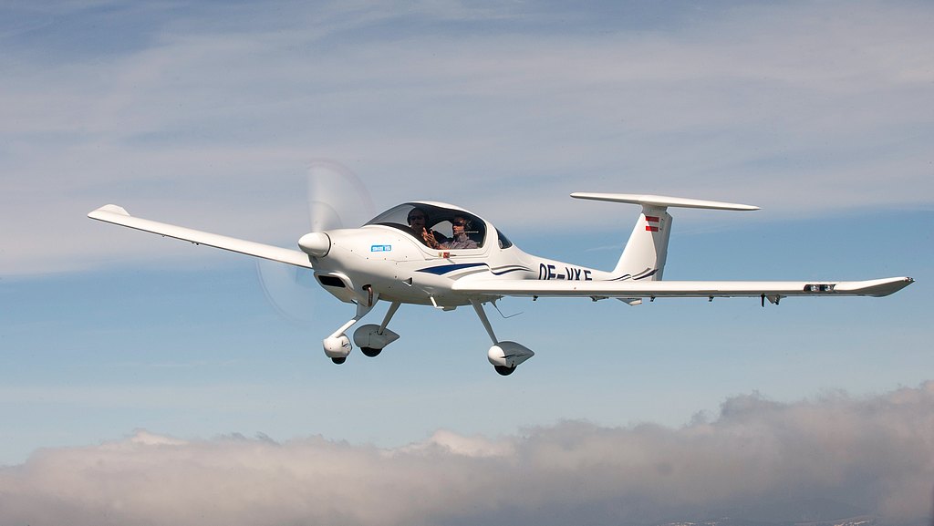 DA20 flying over clouds. 
