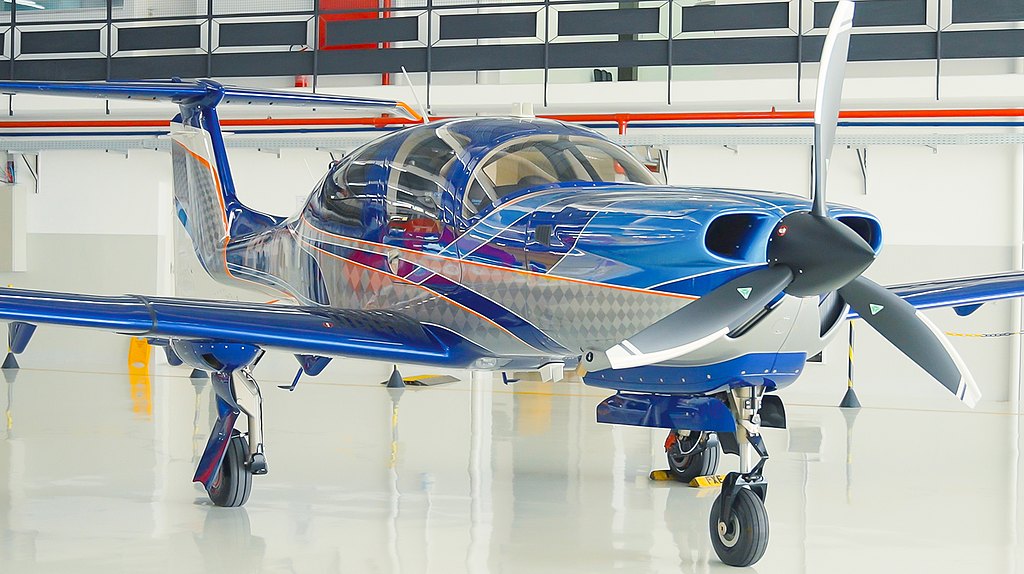DA50 RG in a blue, silver and orange design standing in a hanger. 