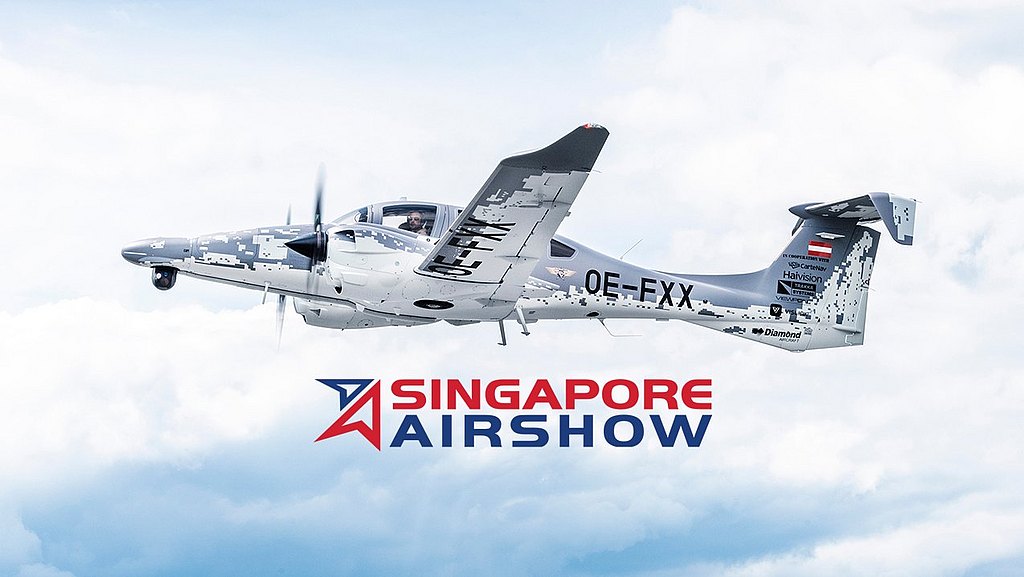 A sleek aircraft with a distinctive owl logo soars through a cloudy sky, showcasing its elegant design and capabilities.